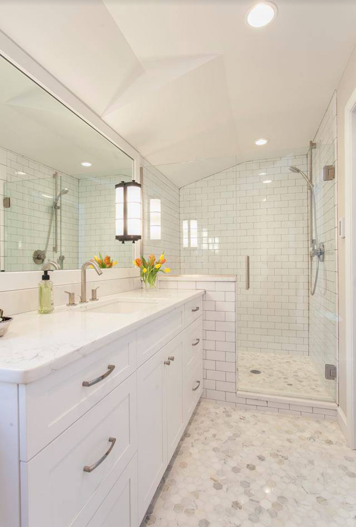 Bathroom with updated fixtures and a custom vanity, featuring sleek faucets, a new sink, and optimized storage.